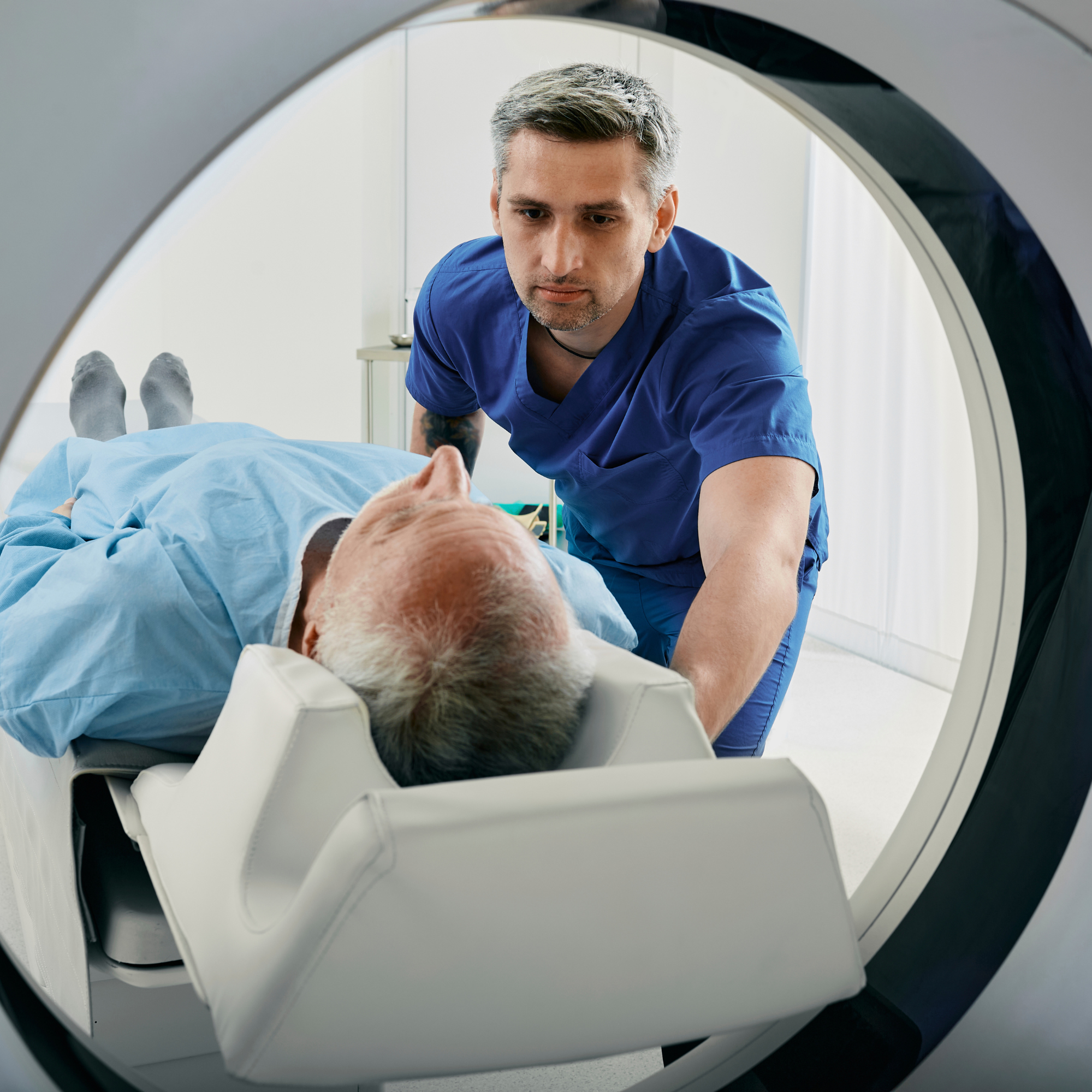 Medical radiation technologist reviewing diagnostic imaging at a workstation
