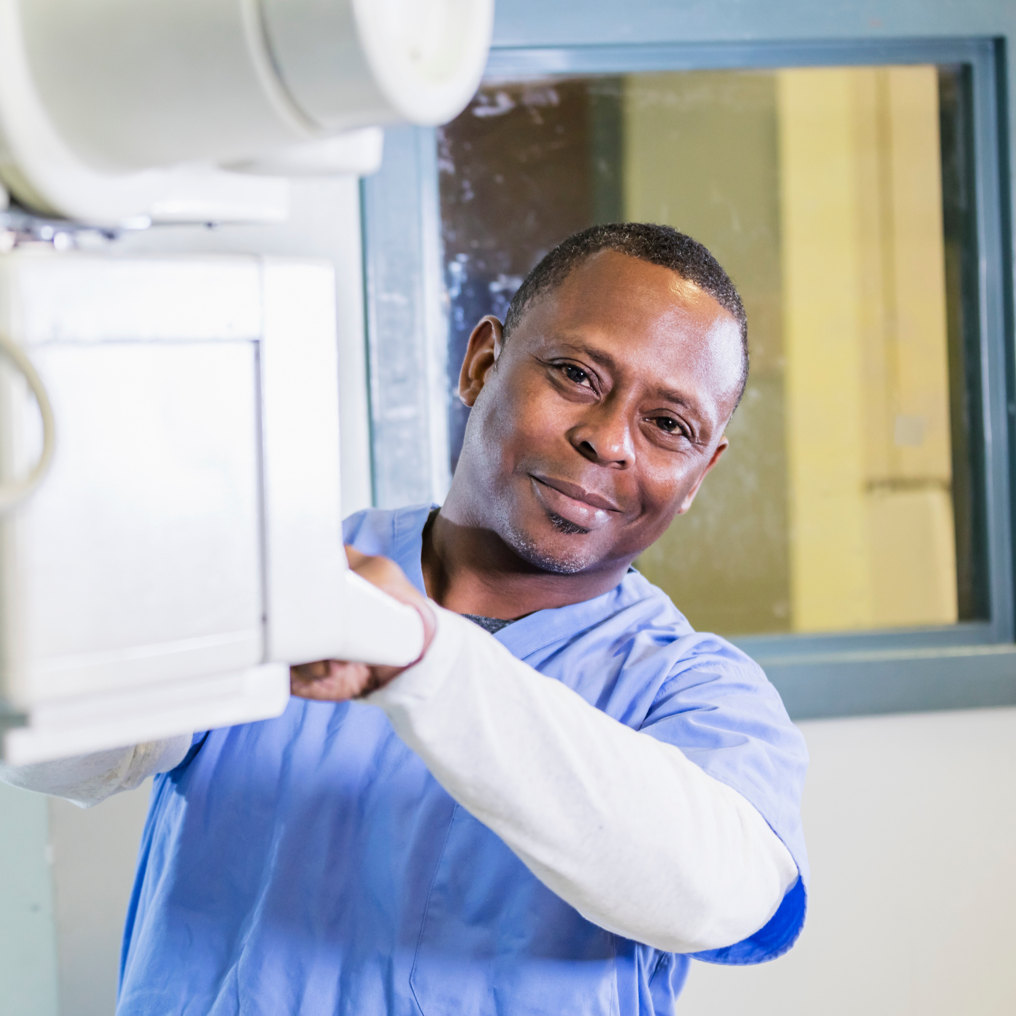 Medical radiation technologist supporting a patient during diagnostic imaging